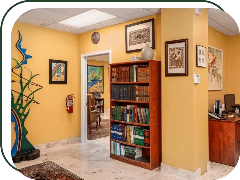 A room with yellow walls and a bookshelf.